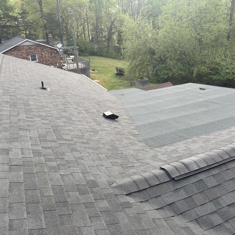 Asphalt shingle roof with roll roofing and vent piping
