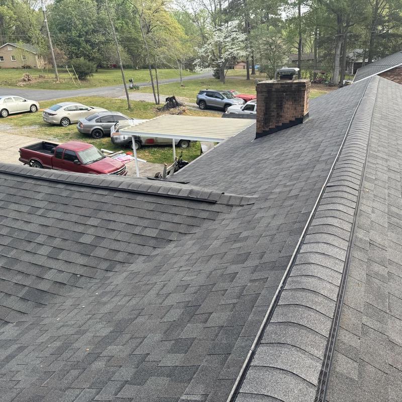 Asphalt shingle roof with chimney and ridge vent