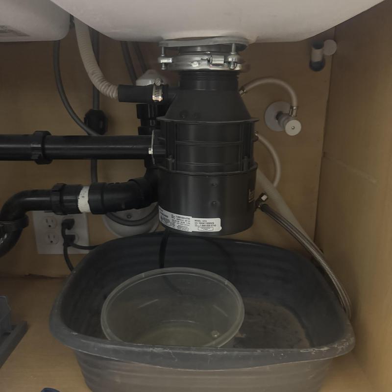 Garbage disposal unit under kitchen sink with drainage pipes Garbage disposal unit under kitchen sink with drainage pipes