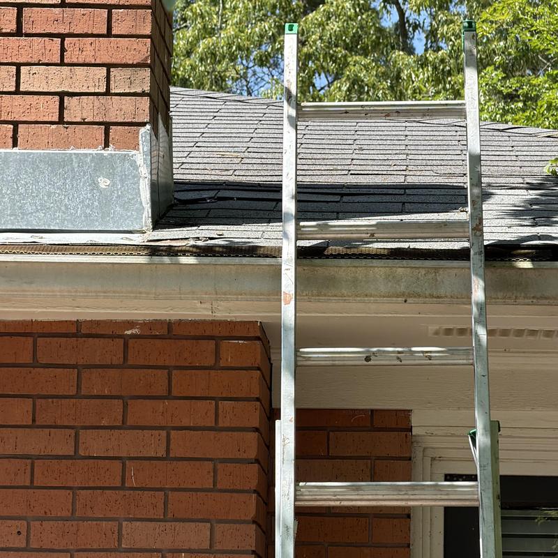 Roof shingles and chimney flashing with ladder setup