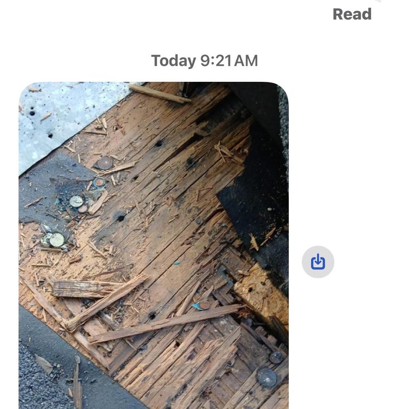 Wooden roof decking with water damage and nails