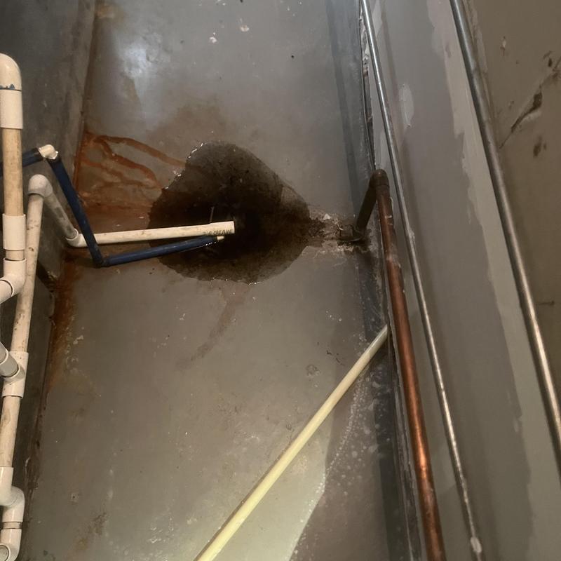 Basement floor drain with mainline clog and water spill