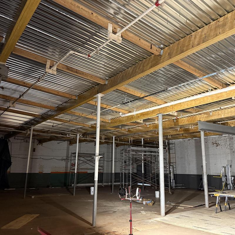 Metal decking installation over structural beams in basement