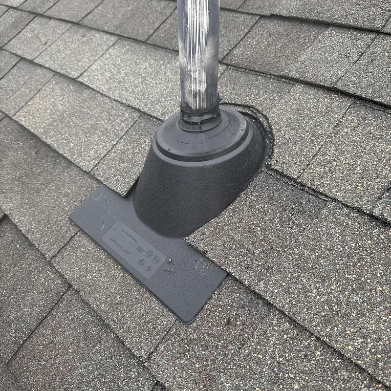 Pipe boot with ice and water flashing on shingle roof