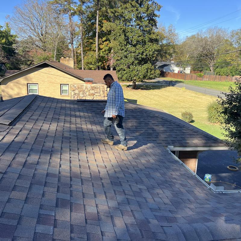 Architectural shingle roof with slope correction worker