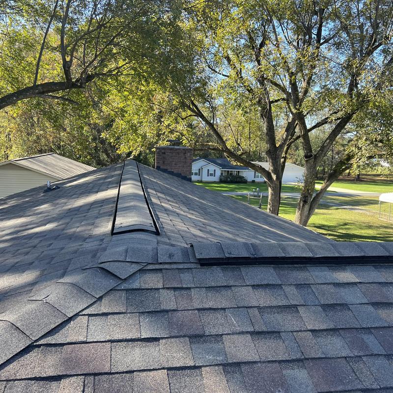 Owens Corning Duration shingle roof with stone chimney