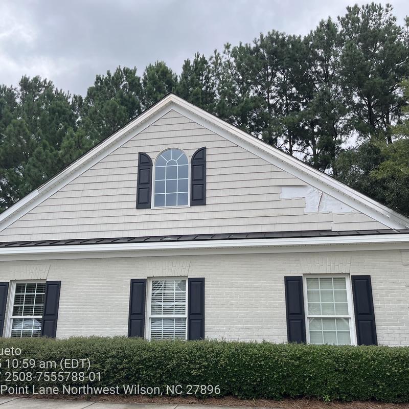 Vinyl siding storm damage patch on house exterior