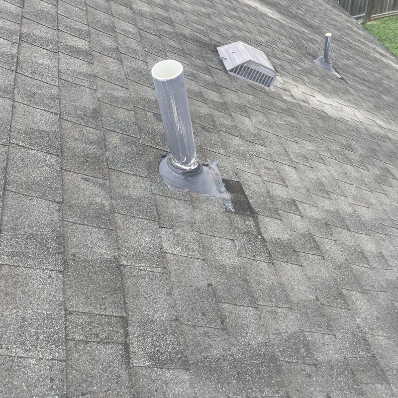 Plumbing vent pipe with new flashing on asphalt roof