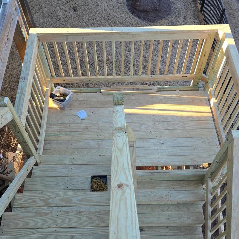 Wooden staircase with railing under construction outdoors