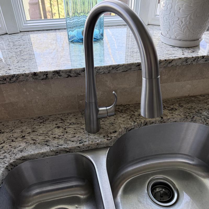 Kohler kitchen faucet on granite countertop with double sink