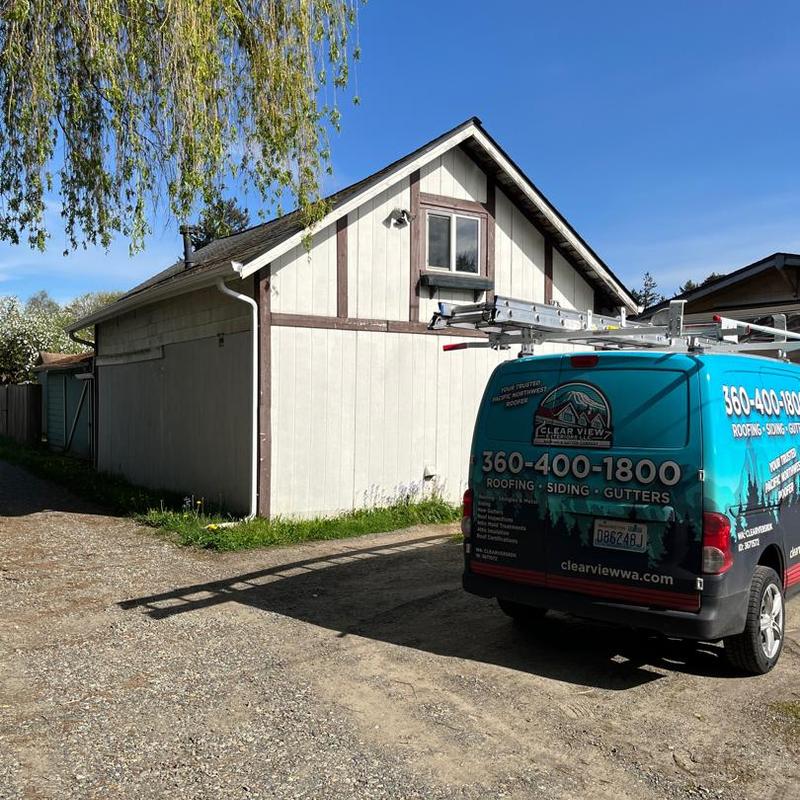 Roof moss removal and cleaning service van parked