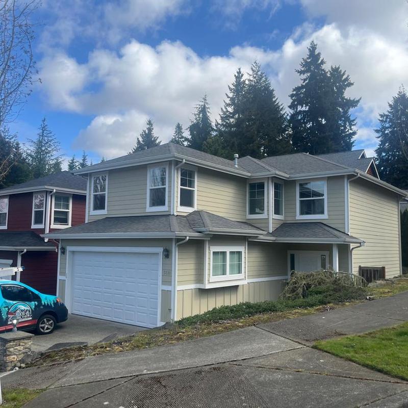 Asphalt shingle roof on two-story house with garage