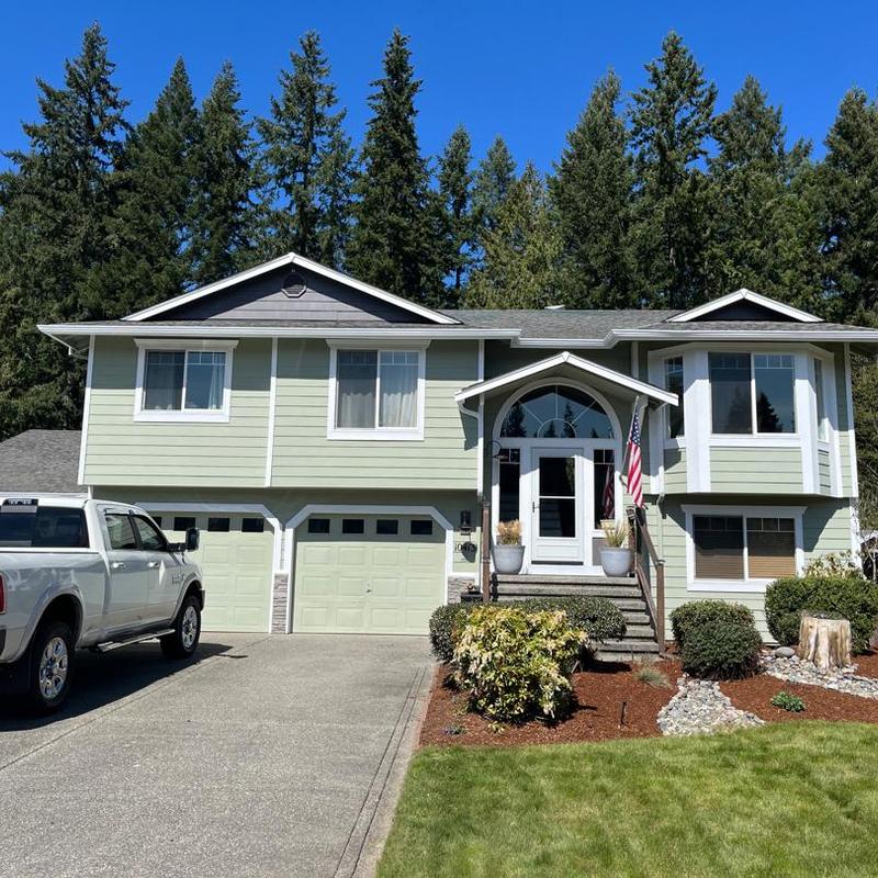 Asphalt shingle roof on green split-level home