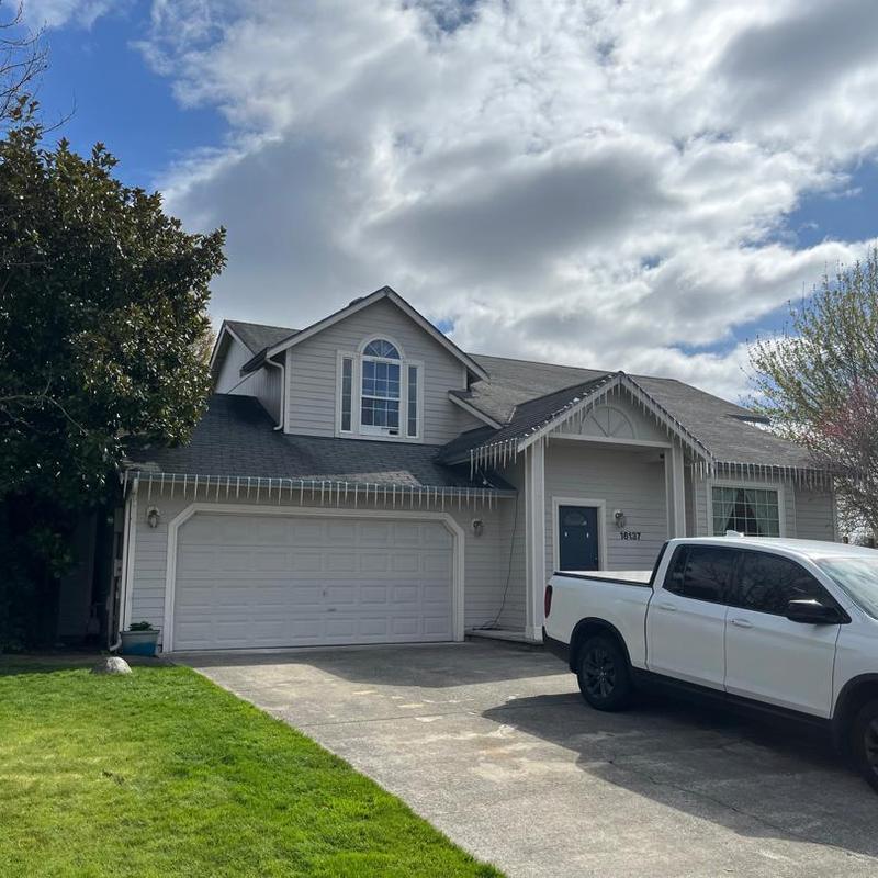 Asphalt shingle roof on two-story suburban home