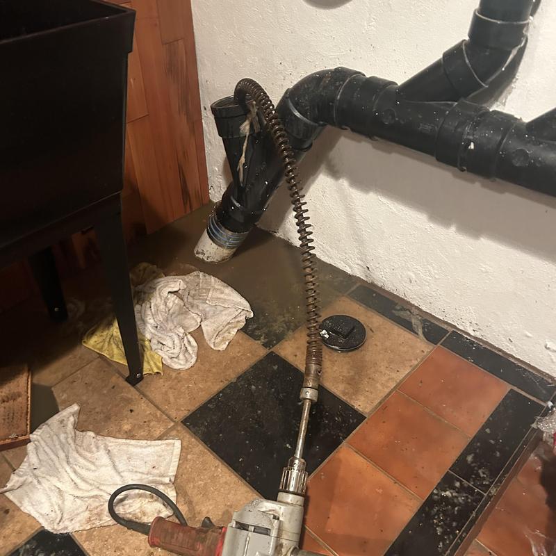 Main line plumbing with snake auger and water backup