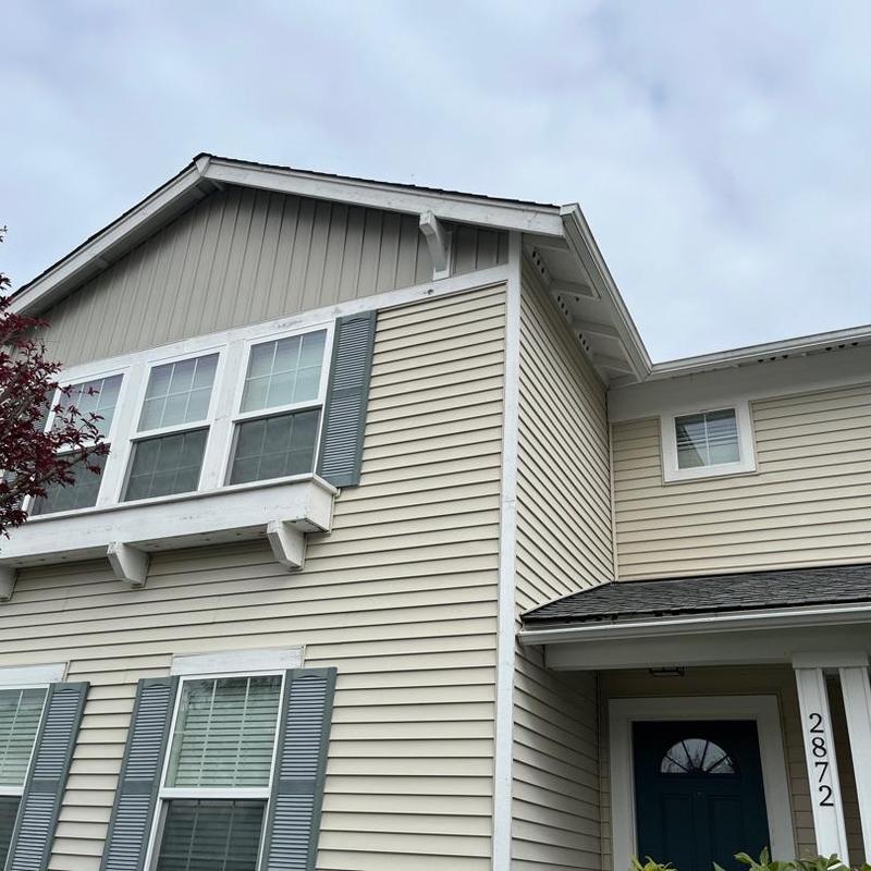 Asphalt shingle roof on beige residential home exterior