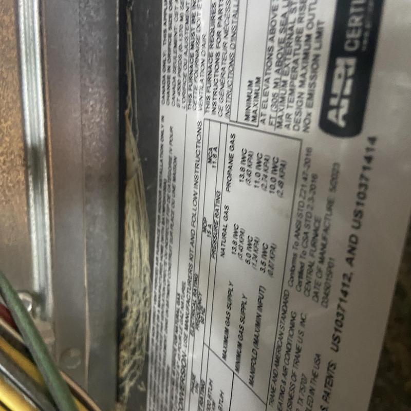 HVAC unit label showing gas rating and safety info