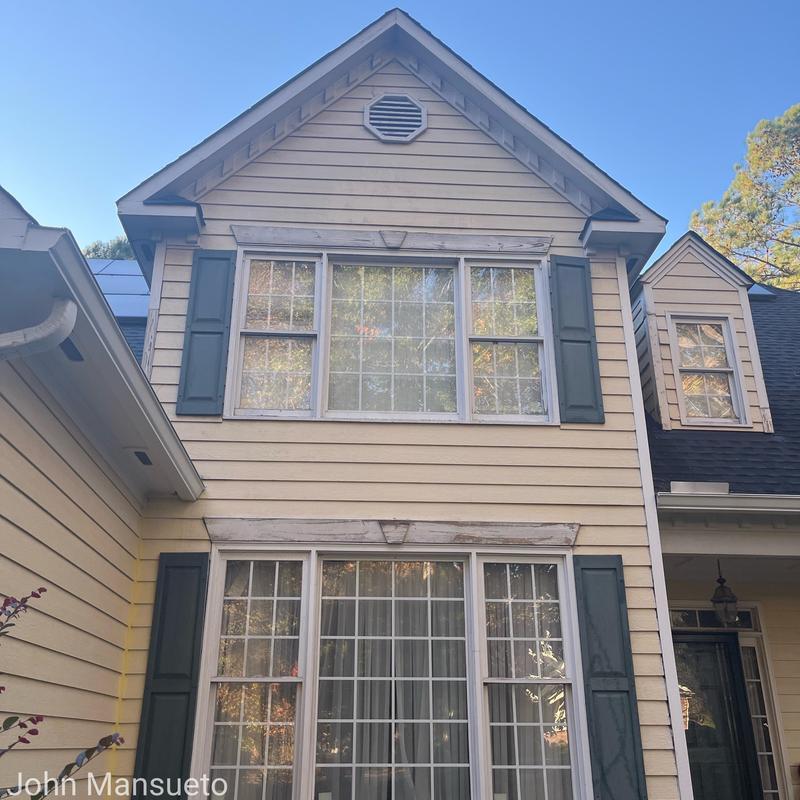 Siding on two-story house with window shutters