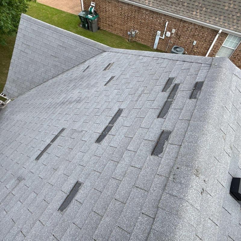 Roof asphalt shingles with missing tabs after wind damage