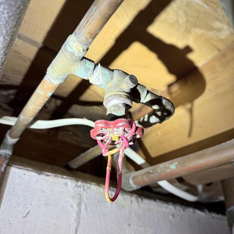 Globe valve with red handle and copper pipe connections