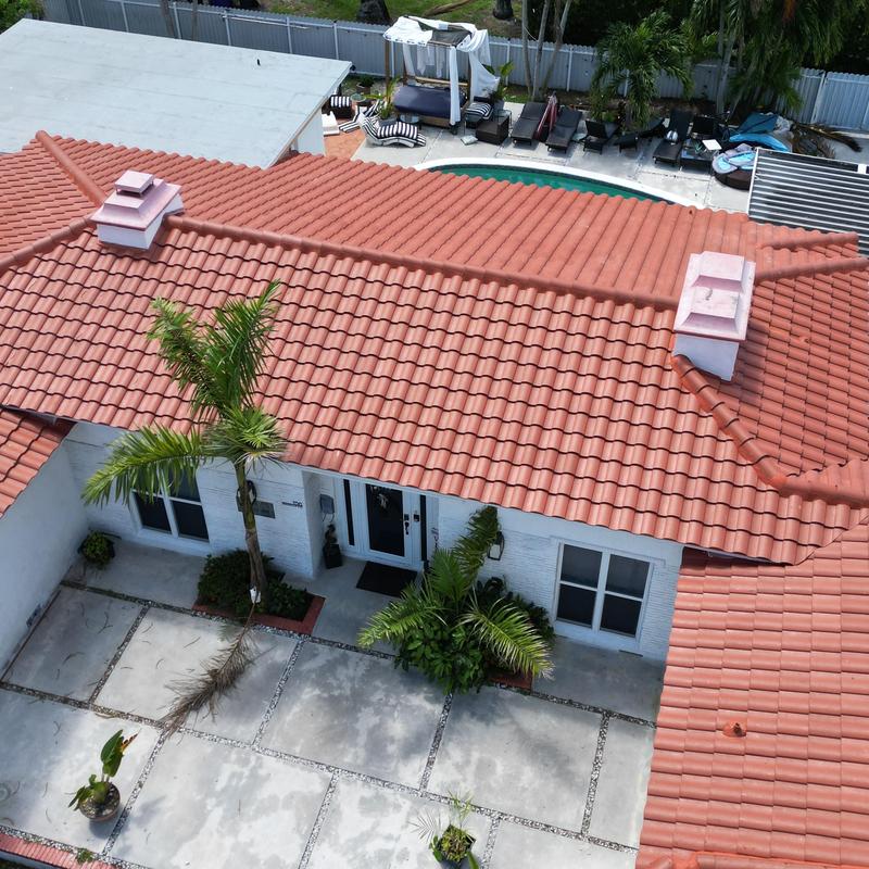 Terracotta tile roof with chimneys and landscaping