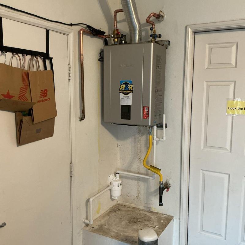 Tankless water heater installation with plumbing connections