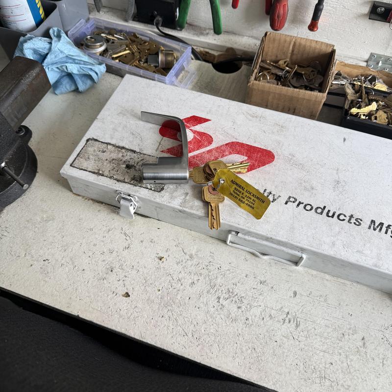 Office door entry lever with attached keys on table