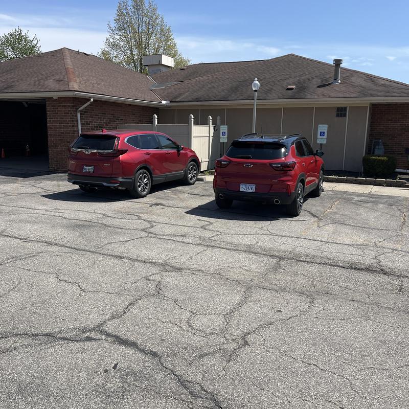 Asphalt parking lot cracks near condominium building