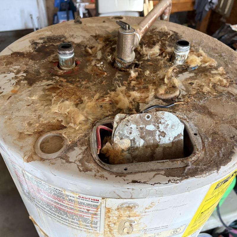 Electric water heater with severe rust and corrosion damage