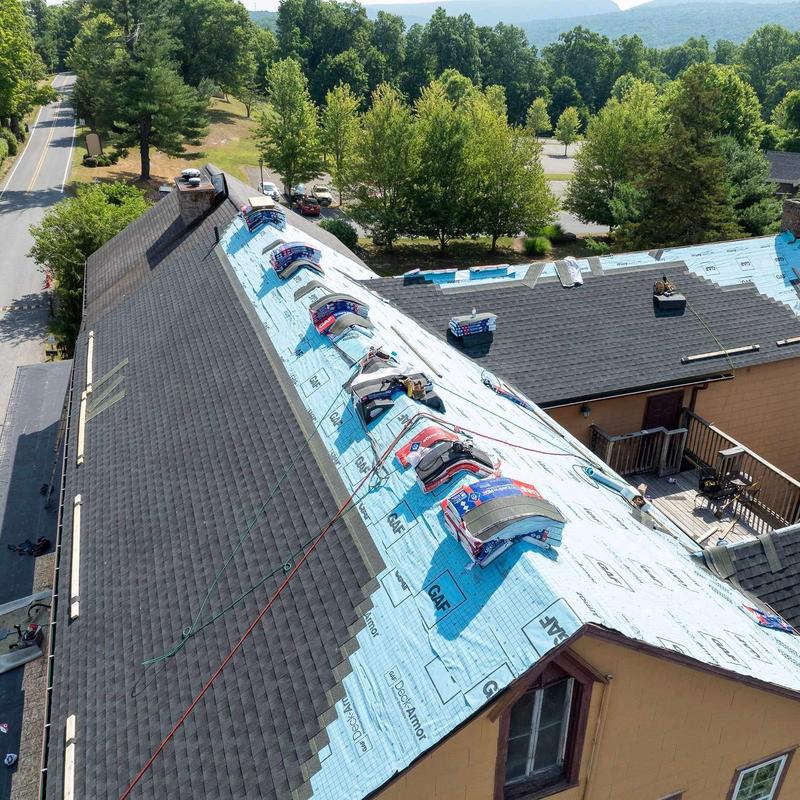 Asphalt shingle roof installation with underlayment in progress Asphalt shingle roof installation with underlayment in progress