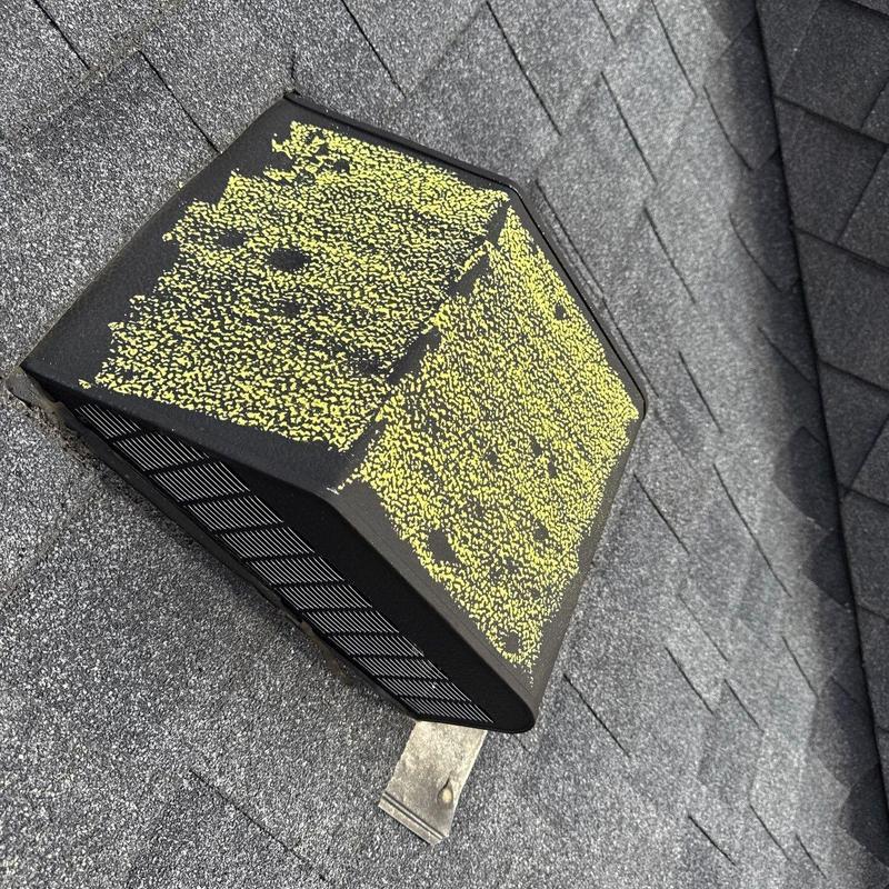 Roof vent with hail damage on shingles and vent cover