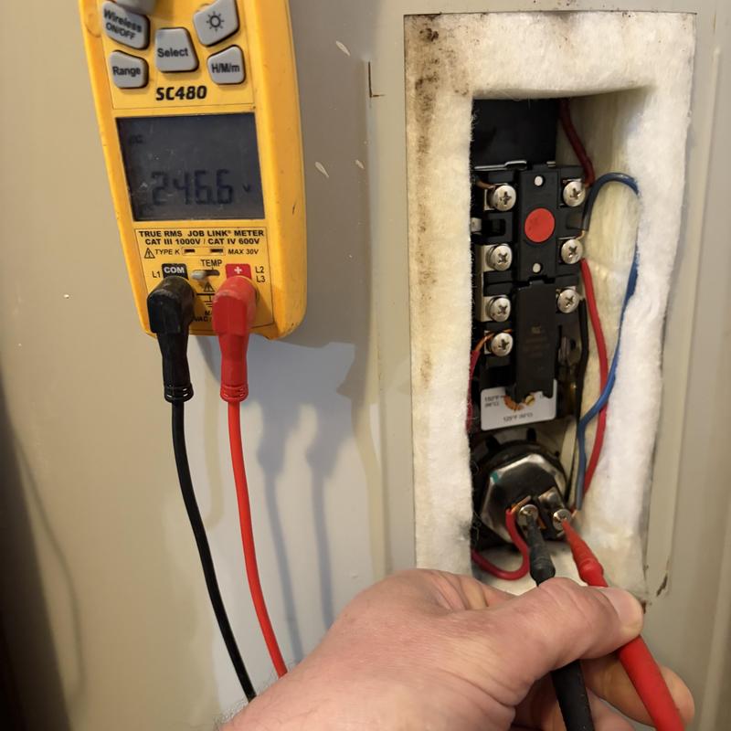 Electric water heater wiring voltage testing with multimeter