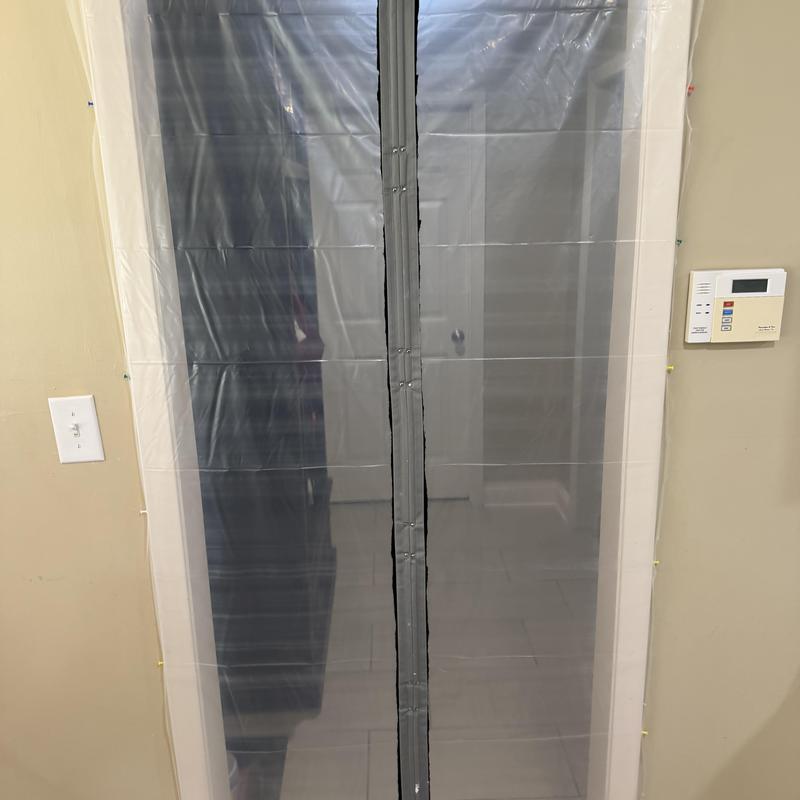 Kitchen doorway sealed with plastic tarp for demo prep