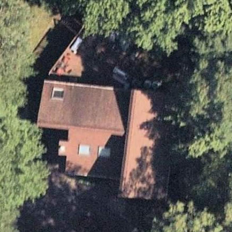 Roof installation on residential house surrounded by trees Roof installation on residential house surrounded by trees
