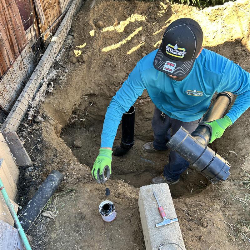 Drain pipe installation with trench hole and plumber