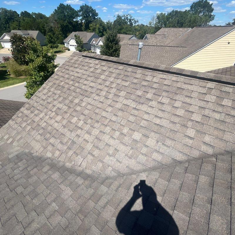 Asphalt shingle roof inspection with hail damage visible