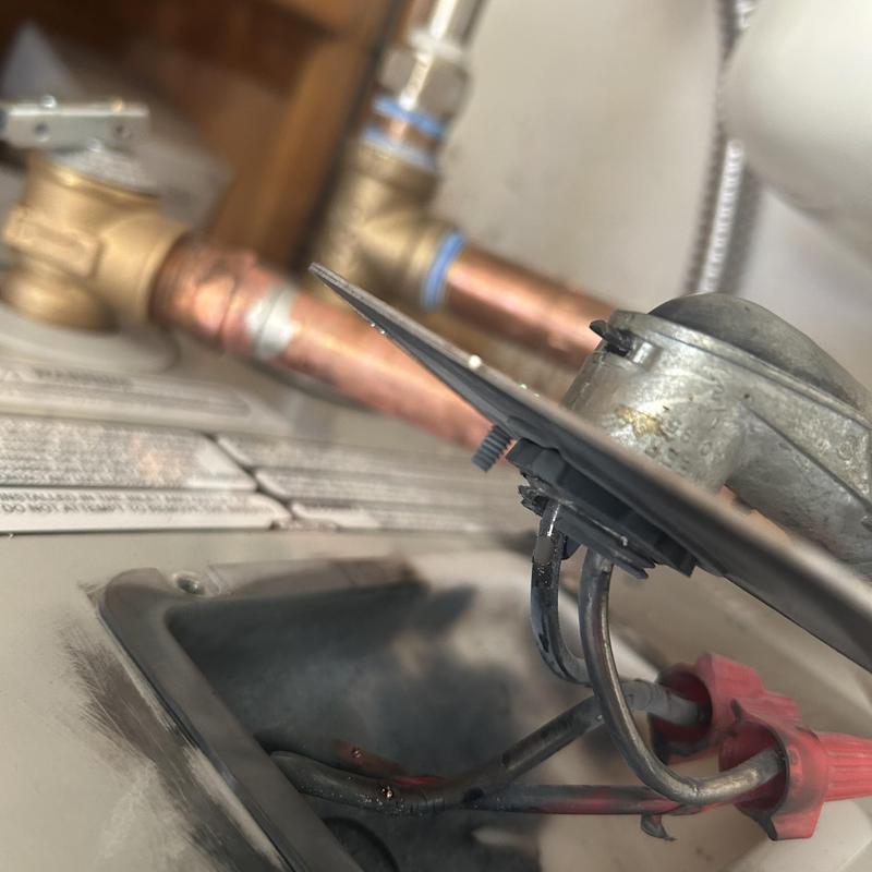 Water heater wiring and piping maintenance close-up