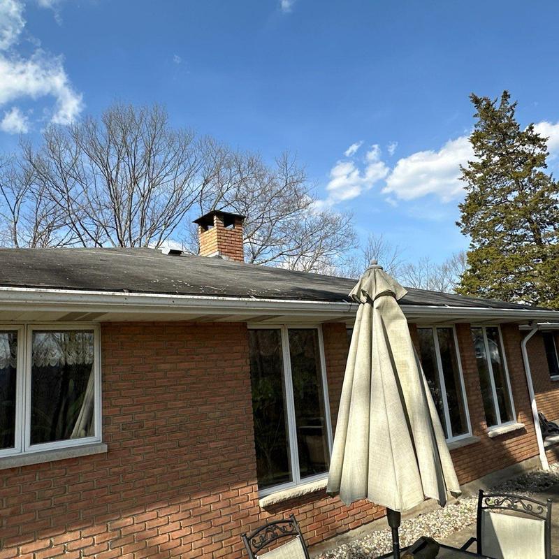 Asphalt shingle roof with visible wear on residential home Asphalt shingle roof with visible wear on residential home
