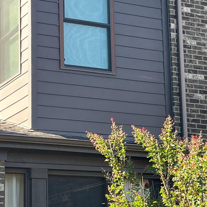 Roof shingles and flashing damage on house exterior