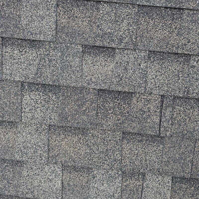Asphalt shingle roof with visible hail damage close-up