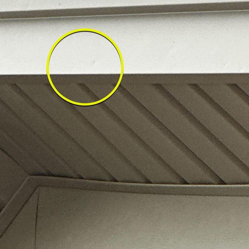 Garage door panel with dent circled in yellow