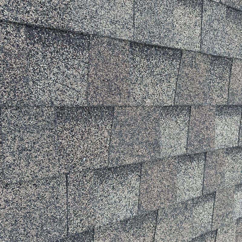 Asphalt roof shingles with hail damage close-up