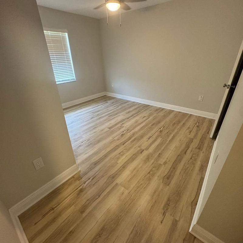 Vinyl plank flooring installation in empty bedroom