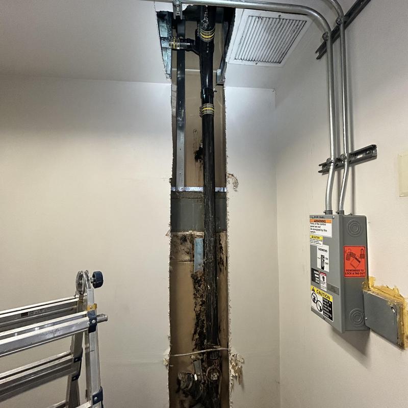 Drain line repair inside commercial building wall