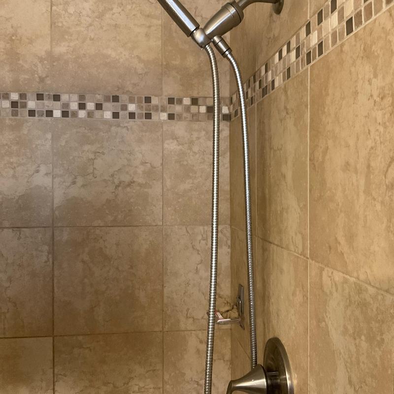 Shower valve and handheld showerhead in tiled shower