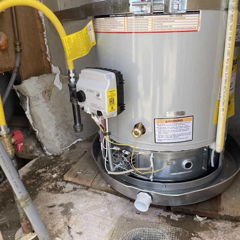 Water heater installation with new gas valve and drain pan