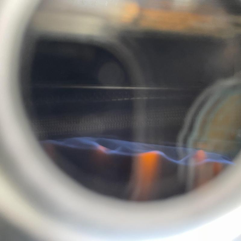 Water heater burner flame inside combustion chamber