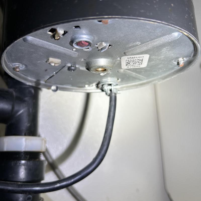 Garbage disposal underside with connected drain pipe
