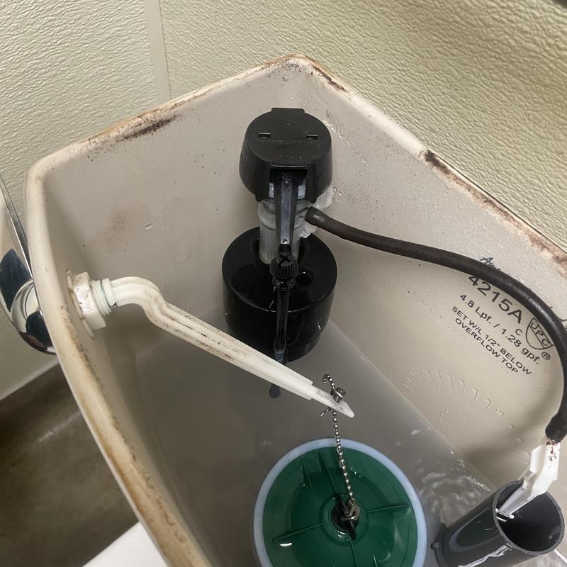 Toilet fill valve and flush assembly inside tank