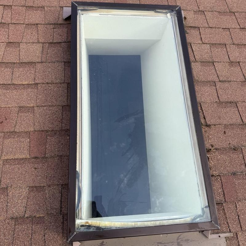 Skylight cleaning and moss treatment on roof